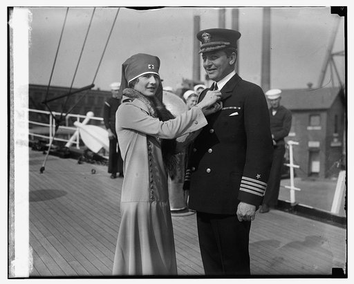 Miss Virginia Hitt pinning cross button on Capt. A.A. Andrews, 11/5/24