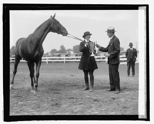 Secty. Jardine presents cup to Miss M.S. Newborg at horse show, 5/21/25