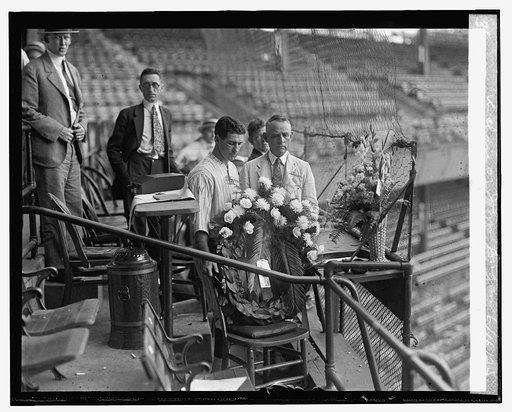 Harris & Griffith place wreath in chair of John Dugan, 6/16/25