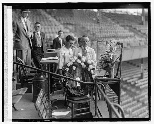 Harris & Griffith place wreath in chair of John Dugan, [6/16/25