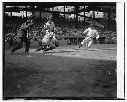 Senators Bucky Harris is out trying to steal home as Indians catcher Luke Sewell gets ready for the tag. The ump is Tommy Connolly. The Senators batter is Ossie Bluege. Senators beat Indians 5-4