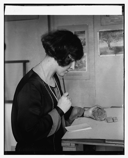 Miss Grace Stockman with ancient clay discs, 1/22/26