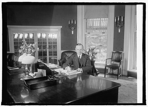 Coolidge at desk in White House, 8/14/23