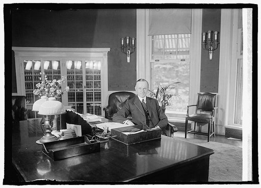 Coolidge at desk in White House, [8/14/23