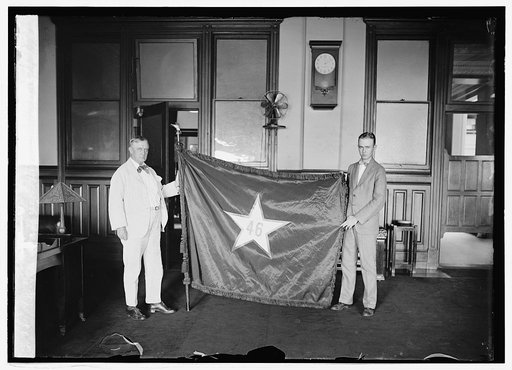 P.M.G. New and Leon H. Moore with Oklahoma state flag, 8/8/24