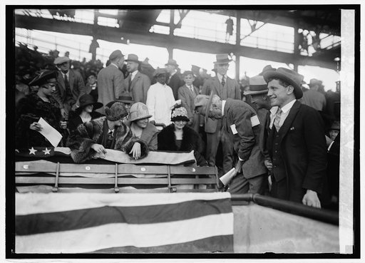 Judge Landis signing scorecards for fans at World Series, 10/10/24