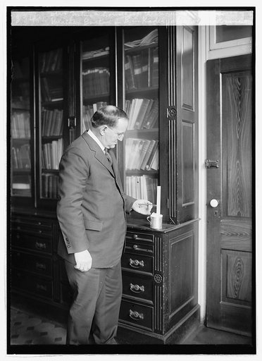 Weather Bureau, B.C. Kadel, Chief of Instrument Div. testing a household thermometer