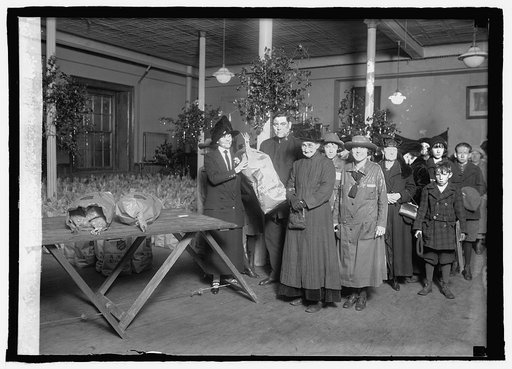 Mrs. Coolidge giving out 1st bag for Salvation Army, 12/24/24