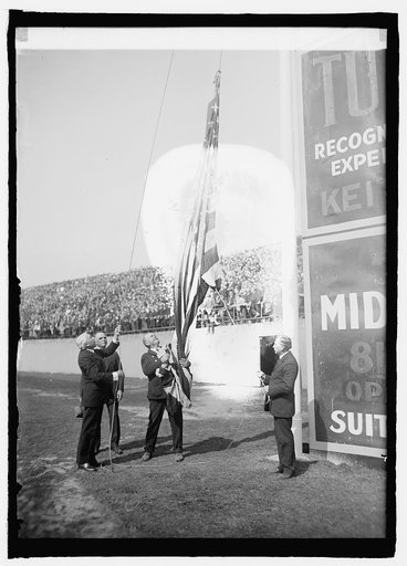 Kellogg raising flag at opening game, 4/22/25