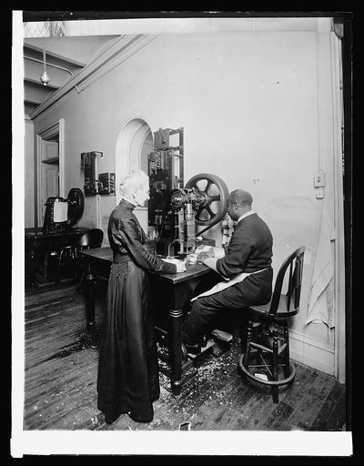 Treasury. First step, destruction of money: machine punches 4 holes in each package, [1914