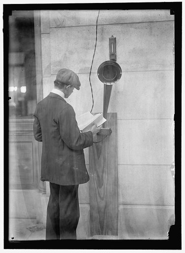 Young man standing near speaker