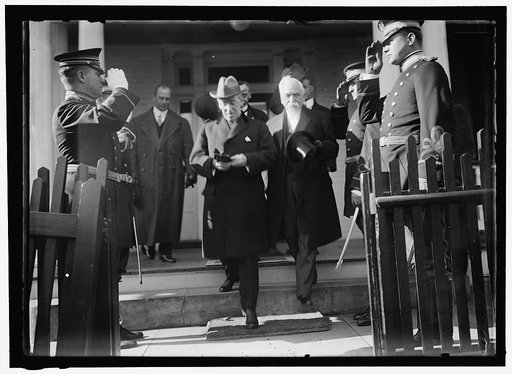 Woodrow Wilson descending steps with unidentified persons