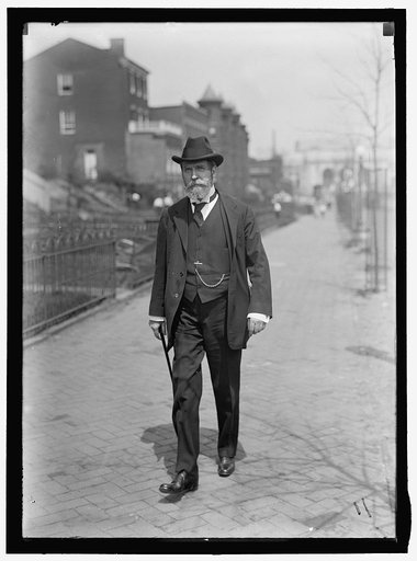 Charles Evans Hughes, 1862-1948, walking away from Union Station, Washington, D.C., perhaps on Louisiana Avenue