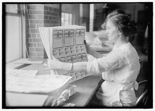 Woman holding $50 bonds, probably Liberty Bonds. Engraving and Printing, Bureau of Treasury Dept.