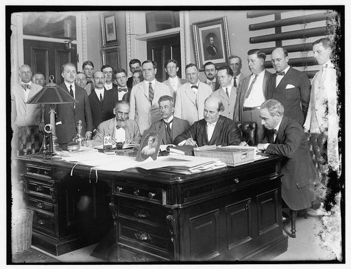 Group: includes William Jennings Bryan (at desk, 2nd from right); and Josephus Daniels, middle of 2nd row
