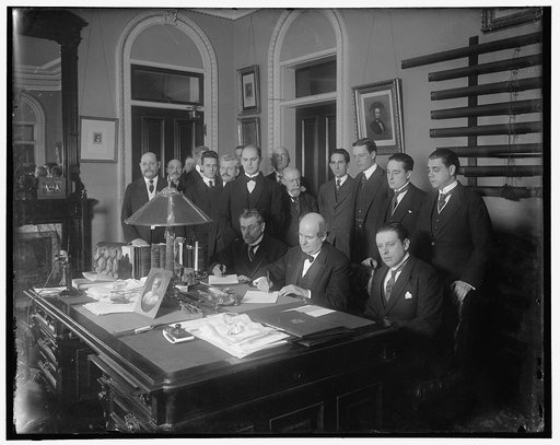 William Jennings Bryan with group at desk
