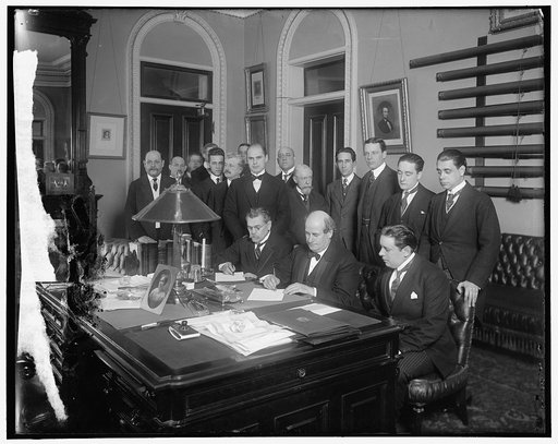 William Jennings Bryan with group at desk