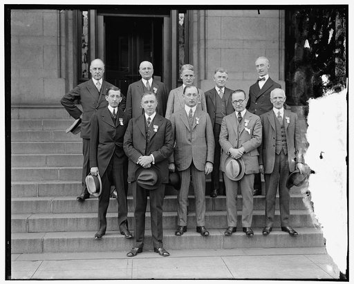 Postmaster General Will Hays with his four assistants. L to R, [Unidentified, First Assistant Postmaster General Hubert Work]; Second Assistant Postmaster General E.H. Shaugnnessy; Third Assistant Postmaster General W. Irving Glover; Fourth Assistant Postmaster General Harry H. Hillany. Back row: W.