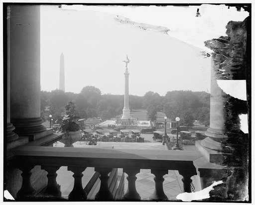 The impressive World War Memorial, the First Division Monument, erected just south of the State War and Navy Building, Washington. It will be dedicated on October 4th. It is a granite shaft with a gold figure at the top. The Washington Monument is shown in background