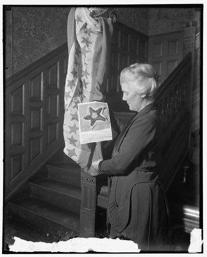 Mrs. Lawrence Lewis holding flag with Hawaiian star