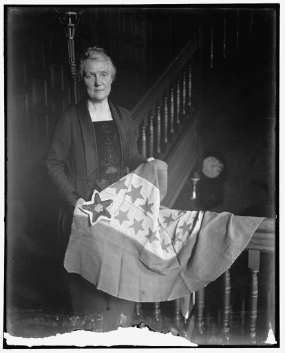 Mrs. Lawrence Lewis holding flag with Hawaiian star