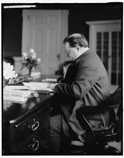 TAFT, WILLIAM HOWARD. AT DESK