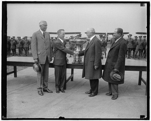 Mackay Trophy is awarded to army av[...] Secretary of War James W. Good, co [...] lating Lieut. Harry A. Sutton, Army [...] aviator, after presenting him the Mackay Trophy for 1928 at Bolling Field, Wash[...] Lieut. Sutton received the trophy for [...] performing the most meritorious flight [...] Ar
