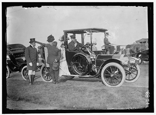 LONGWORTH, MRS. NICHOLAS. SITTING IN DOOR OF AUTO; WITH MRS. TAFT