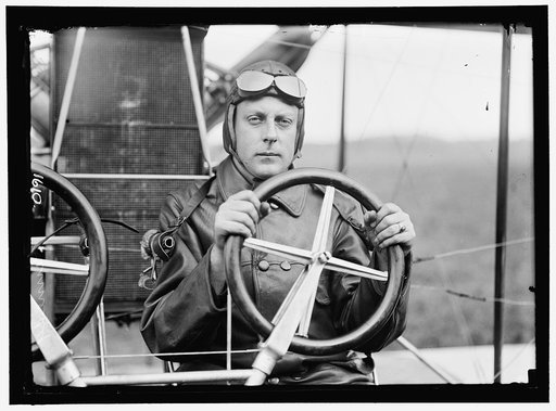 KENNEDY, FRANKLIN. LT., U.S.A. AVIATOR. IN CURTISS DUAL CONTROL AIRPLANE, HEADLESS; COLLEGE PARK, MARYLAND