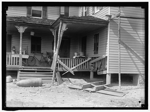 INDIAN HEAD, MD. NAVY PROVING GROUND. RESIDENCE OF GEORGE SWANN, DAMAGED BY 16' SHELL THAT HIT ANOTHER IN SANDBANK, AND WAS DEFLECTED OVER COUNTRY AT 3/4 ANGLE. THE SHELL, WHERE IT STOPPED IN DOORYARD