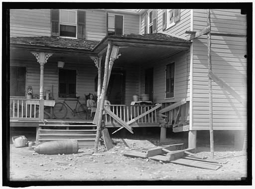 INDIAN HEAD, MD. NAVY PROVING GROUND. RESIDENCE OF GEORGE SWANN, DAMAGED BY 16' SHELL THAT HIT ANOTHER IN SANDBANK, AND WAS DEFLECTED OVER COUNTRY AT 3/4 ANGLE. THE SHELL, WHERE IT STOPPED IN DOORYARD