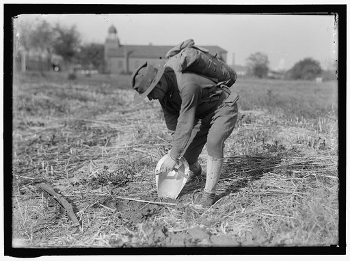 MAHON, LEONARD D. WITH STEEL HELMET HE INVENTED THAT COULD BE USED AS SHOVEL