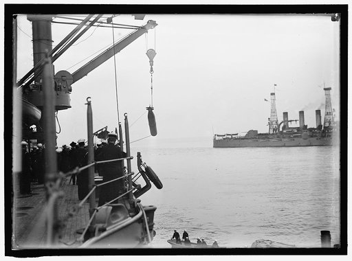 TARGET PRACTICE. HAULING TORPEDOES ON BOARD