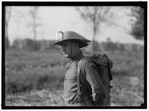 MAHON, LEONARD D. WITH STEEL HELMET HE INVENTED THAT COULD BE USED AS SHOVEL