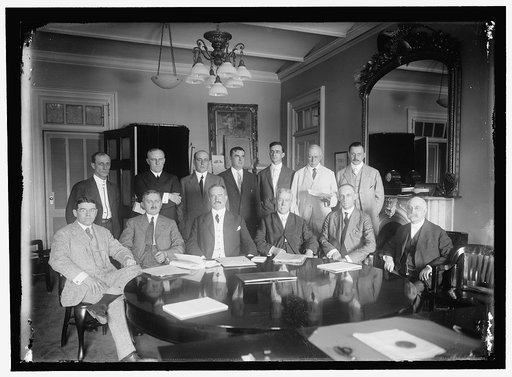 FEDERAL BANK EXAMINERS. SITTING: J.D. BRENNAN; P.M. KERST; JOHN SKELTON WILLIAMS, COMPTROLLER OF TREASURY; T.P. KANE; J.D. RISING; E.I. JOHNSON. STANDING: C.H. ABBOTT; J.C. CHIDSEY; C.E. FRENCH; S.H.L. CO