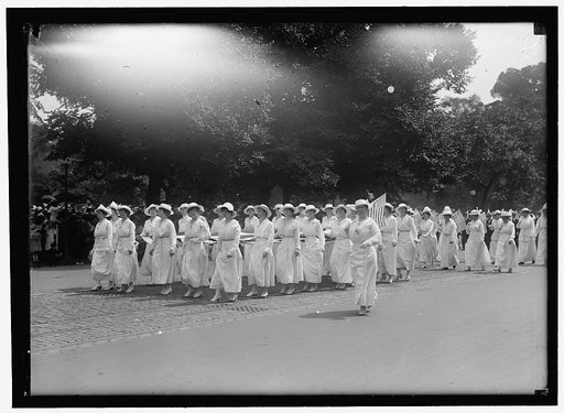 PREPAREDNESS PARADE. MANY WOMEN CARRYING HUGE FLAG