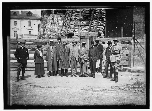 RHEIMS. AMERICAN WAR CORRESPONDENTS: FRENCH OFFICER; MRS. HARRIET C. ADAMS; PAUL CRAVATH; CAPT. PAUL DUMAS, WEARING ARTIFICIAL HAND ANDARM; UNIDENTIFIED; CHARLES EDWARD RUSSELL; UNIDENTIFIED; JUDGE ROBERT GRANT. IN FRONT OF CATHEDRAL