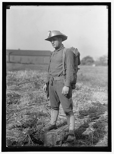MAHON, LEONARD D., WITH STEEL HELMET HE INVENTED THAT COULD BE USED AS SHOVEL