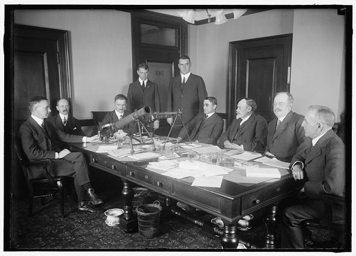 MACHINE GUN BOARD OF WAR DEPARTMENT. TRACY DIXON, STANDING LEFT; BRIG. GEN. TODD, 2ND OR 3RD FROM LEFT; NEWTON D. BAKER, 4TH FROM RIGHT; LAWRENCE B. BENET, 3RD FROM RIGHT; MAJ. GEN. DICKMAN, 2ND FROM RIGHT. OTHERS UNIDENTIFIED