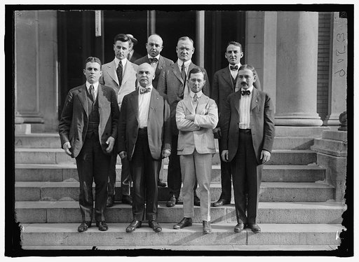 REED, DANIEL ALDEN. LECTURER ON COM. AND CIVIL SUBJECTS. REP. FROM NEW YORK, 1919-. 2ND FROM RIGHT, REAR, WITH UNIDENTIFIED GROUP