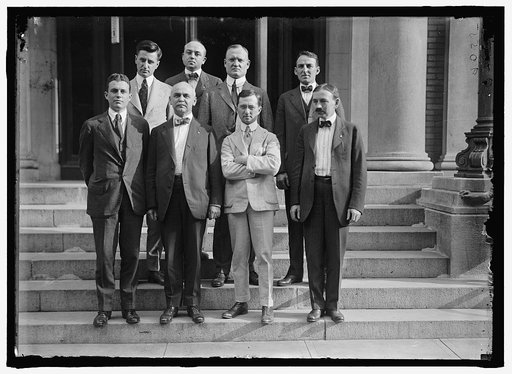 REED, DANIEL ALDEN. LECTURER ON COM. AND CIVIL SUBJECTS. REP. FROM NEW YORK, 1919-. 2ND FROM RIGHT, REAR, WITH UNIDENTIFIED GROUP