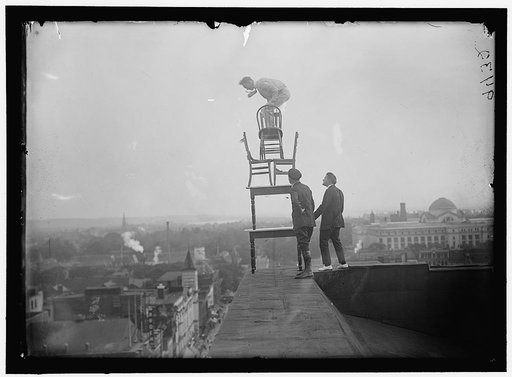 REYNOLDS, J., PERFORMING ACROBATIC AND BALANCING ACTS ON HIGH CORNICE ABOVE 9TH STREET, N.W.