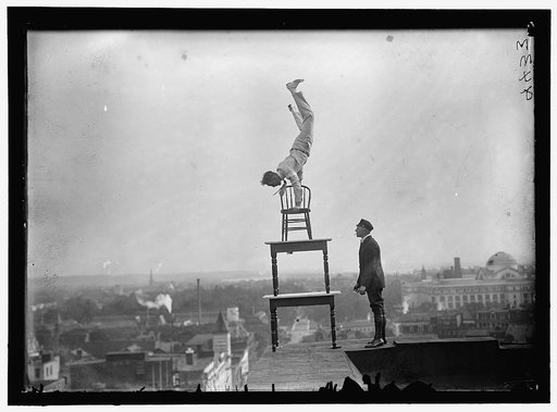 REYNOLDS, J., PERFORMING ACROBATIC AND BALANCING ACTS ON HIGH CORNICE ABOVE 9TH STREET, N.W.