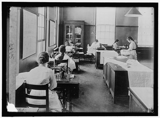 GIRL SCOUTS. WAR SEWING WITH RED CROSS