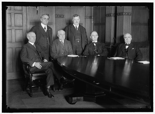 RAILWAY WAGE COMMISSION. CREATED JANUARY 18, 1918 BY DIRECTOR GENERAL OF RAILROADS. SEATED: J.H. COVINGTON; FRANKLIN K. LANE; CHARLES C. McCHORD; WILLIAM R. WILCOX. STANDING: W.A. RYAN; F.W. LEHMAN