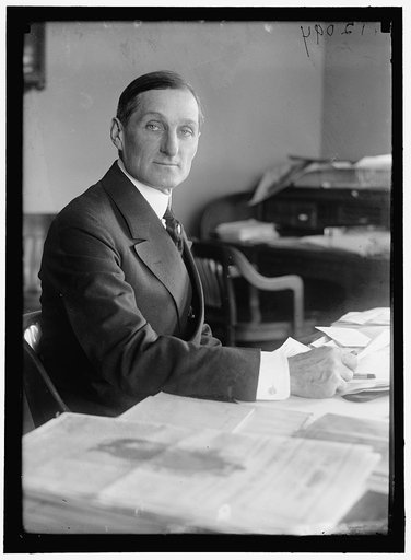 McADOO, WILLIAM GIBBS. SECRETARY OF THE TREASURY, 1913-1921. AT DESK