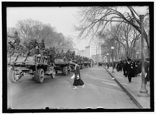 ARMY, U.S. SOLDIERS GOING THROUGH CITY IN TRUCKS AND AUTOS