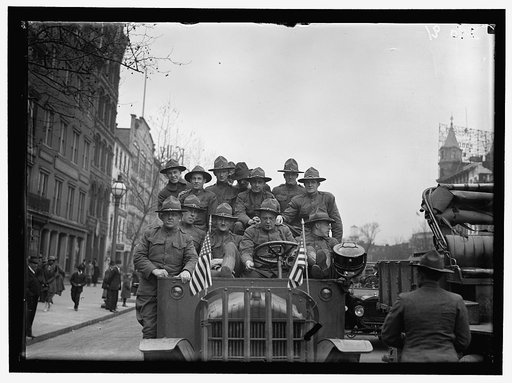 ARMY, U.S. SOLDIERS GOING THROUGH CITY IN TRUCKS AND AUTOS