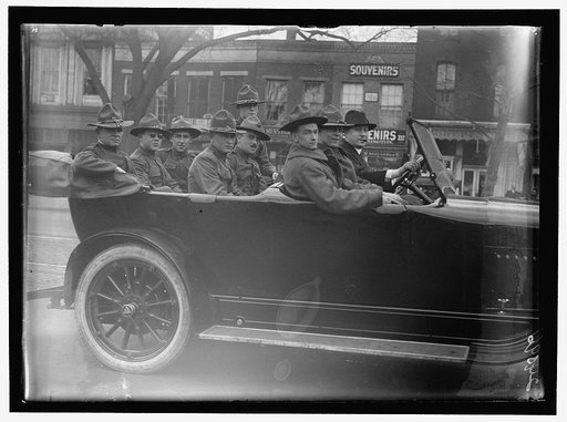 ARMY, U.S. SOLDIERS GOING THROUGH CITY IN TRUCKS AND AUTOS