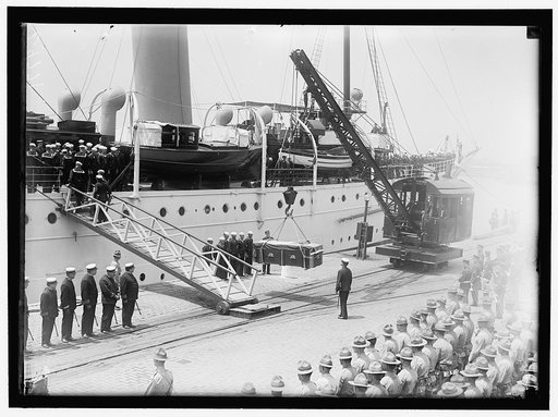 ALDUNATE, SANTIAGO. AMBASSADOR FROM CHILE. AFTER FUNERAL, TAKING BODY TO NAVY YARD AND PLACING ON SHIP. PALLBEARERS AT FUNERAL IN GROUP ARE SEC. LANSING, REPS. HOOD AND GOODWIN, AND SEN. POMERENE